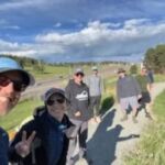 group of people gathering to go on hike, standing on trail