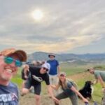 group of people with a dog hiking on trail
