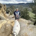 man with his dog on hiking trail