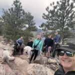 group of hikers with their dogs on trail