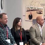 three people leading event