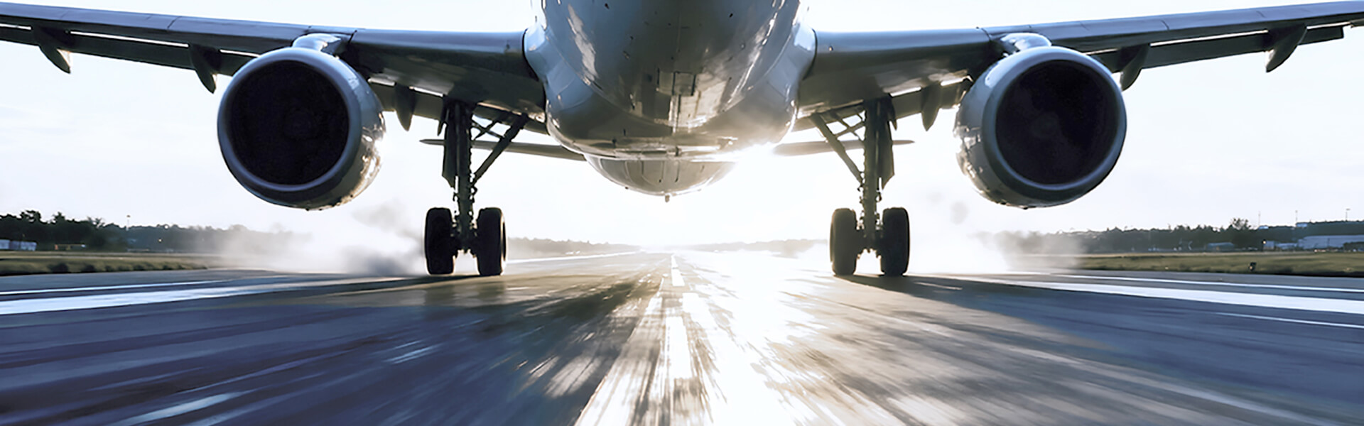 An airplane is seen taking off on a runway during sunset