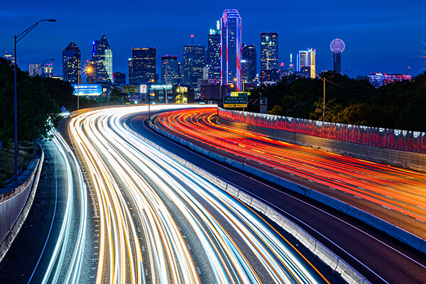 traffic at night with dallas skyline