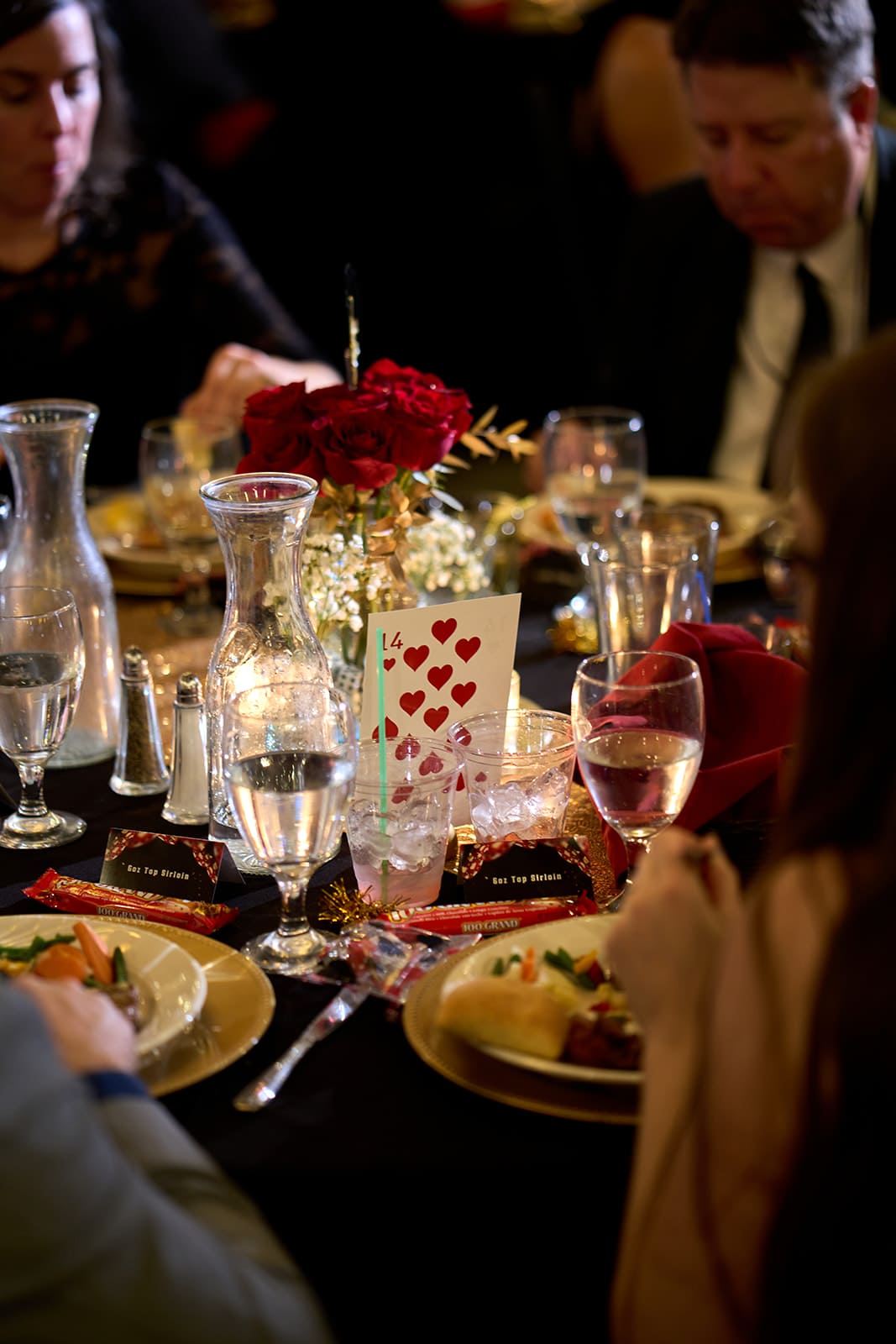 Table centerpiece with roses and candles at the chamber casino night gala