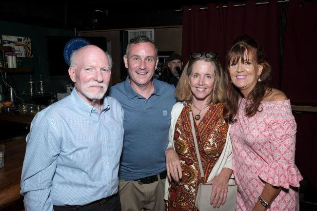 Four IBO members pose for photo at an evening event.
