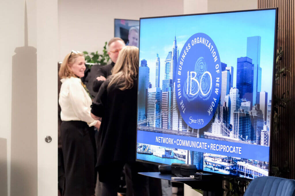Irish Business Organization of New York IBO logo on a wide screen TV.