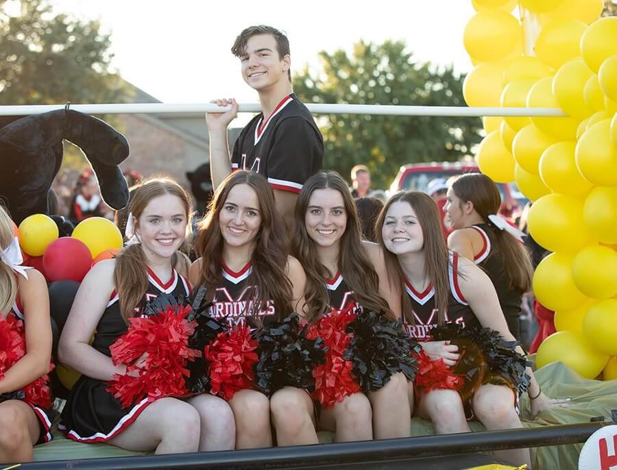 varsity cheerleaders at homecoming parade