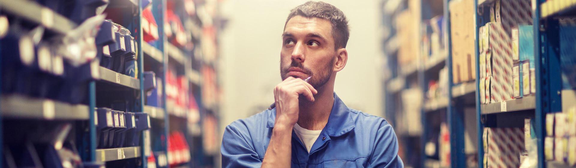 car service, repair, maintenance and people concept - auto mechanic man or smith with clipboard at workshop or warehouse S