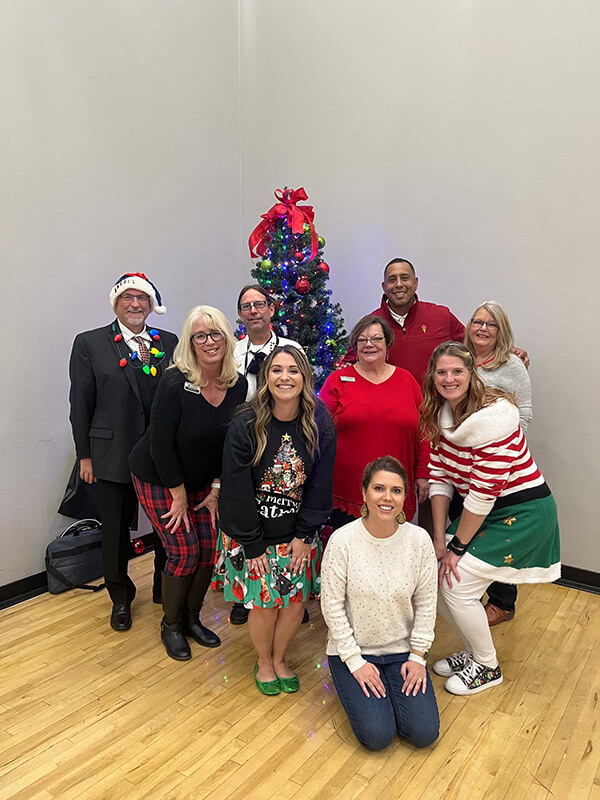 staff gathered around the Christmas tree