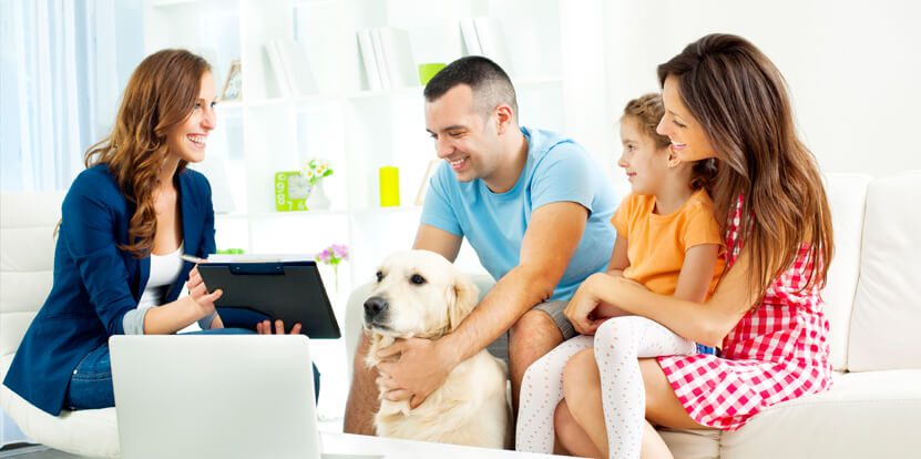 family with dog talking to mortgage broker