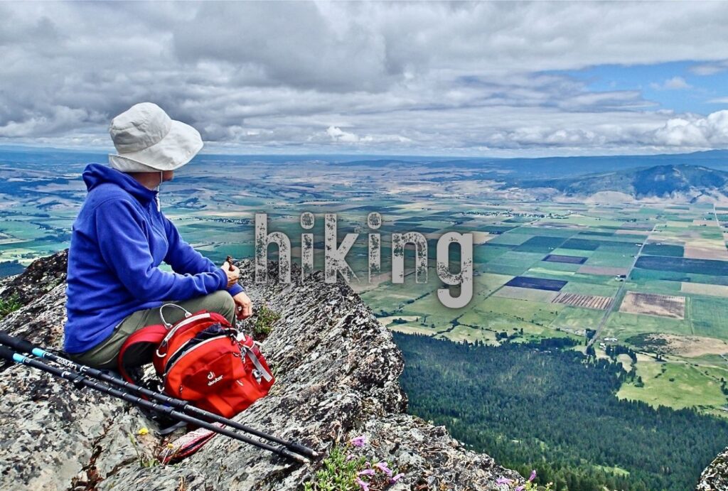 lady sitting on a rock at view point after a hike