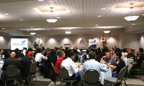 photo of full room and people around tables