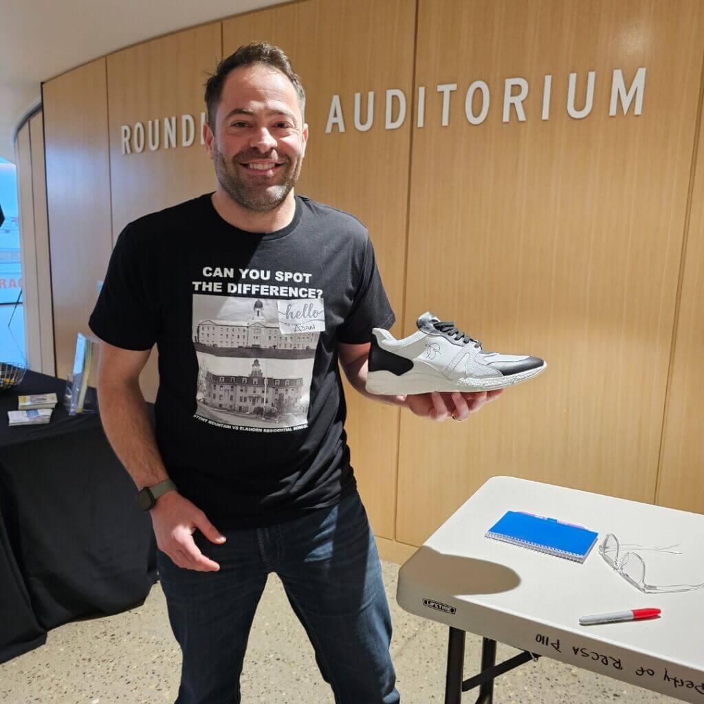 Adam Nepon holding signed RRA Ogimaa shoes