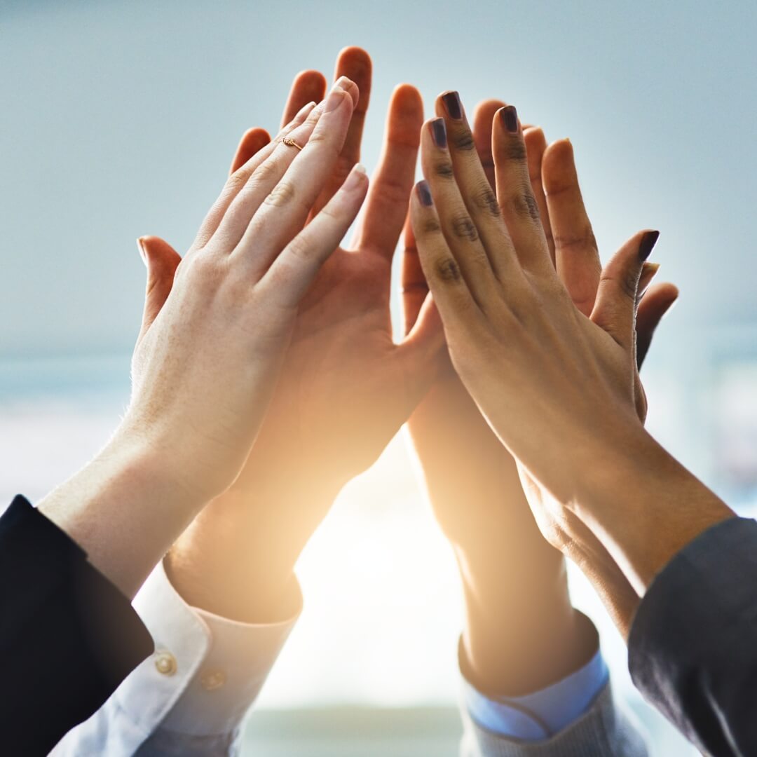 group of business people giving a high five