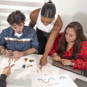 data-collection-matters people gathered at meeting table and reviewing various charts and data