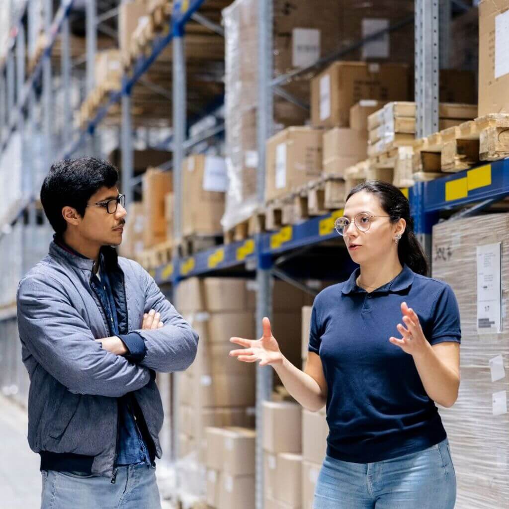 Warehouse workers discussing on supply chain management