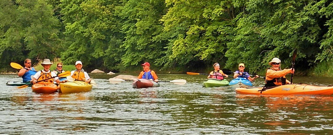people kayaking on a river