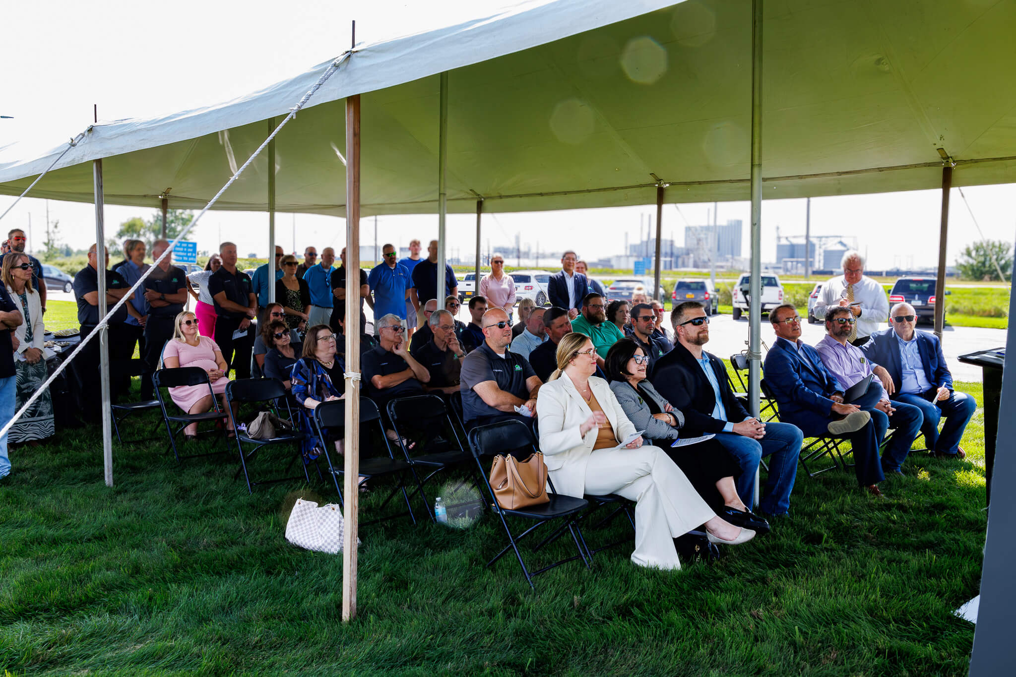 Photo Of Group under tent sitting in chairs