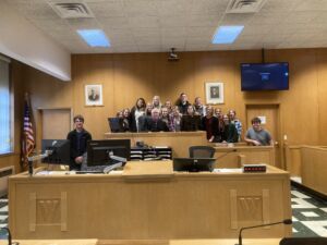 Group picture with judge at courthouse in courtroom