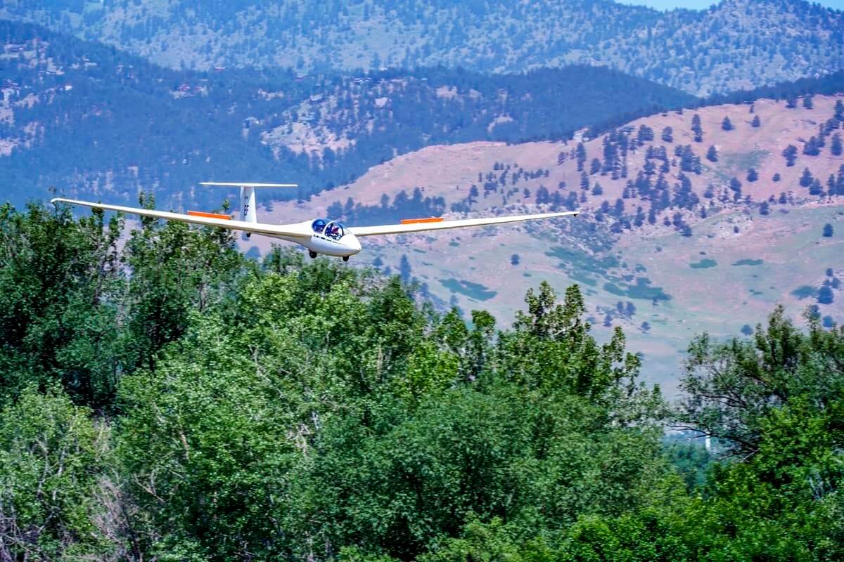 A beautiful Schleicher ASK 21, run by the Soaring Society of Boulder, comes in to land with its crew of two.