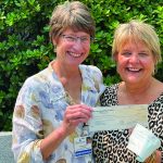 Laura Gingrass from Monadnock Community Hospital hands over a GKPC check to Ellen Avery from the Volunteer Transportation Company, who MCH chose to receive 50% of their charity golf sponsorship!