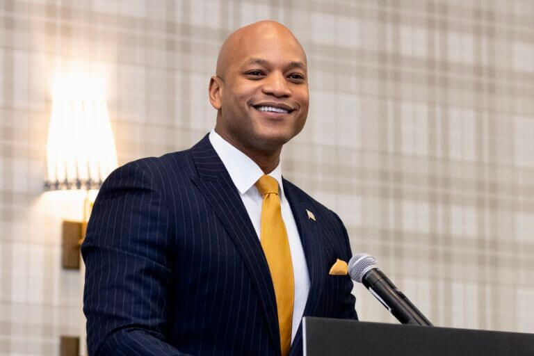 Maryland Governor Wes Moore speaking at a podium and microphone during the Maryland Chamber of Commerce's 2023 State of the State event.