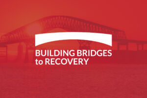 Red opaque graphic with Key Bridge at sunset in background with the Building Bridges to Recovery campaign logo in white above.