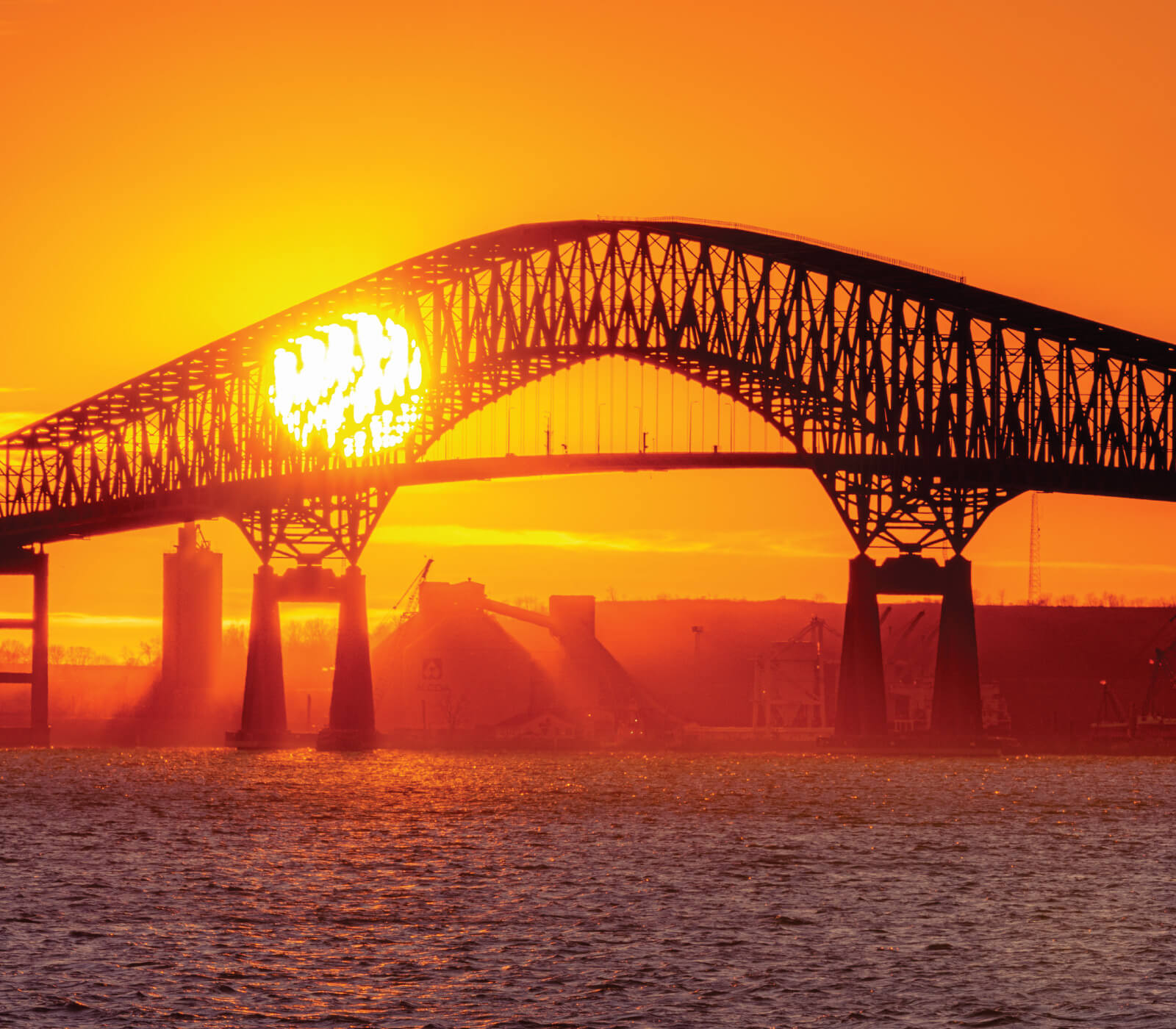 Sun setting behind former Key Bridge in Baltimore, Maryland