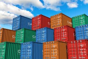 Stacked cargo containers in storage area of freight port terminal.