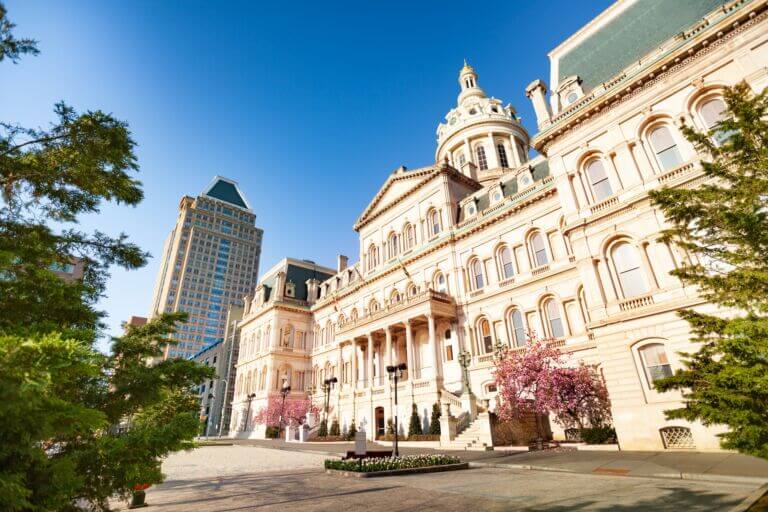 Exterior view of the front facade of Baltimore City Hall in Baltimore, Maryland on a sunny spring day