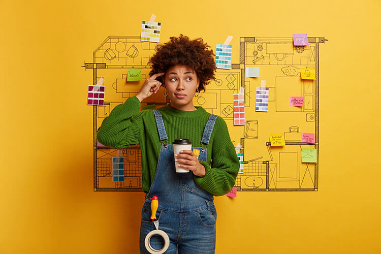 woman holding coffee in front of idea board