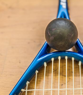 squash racquet and ball on floor