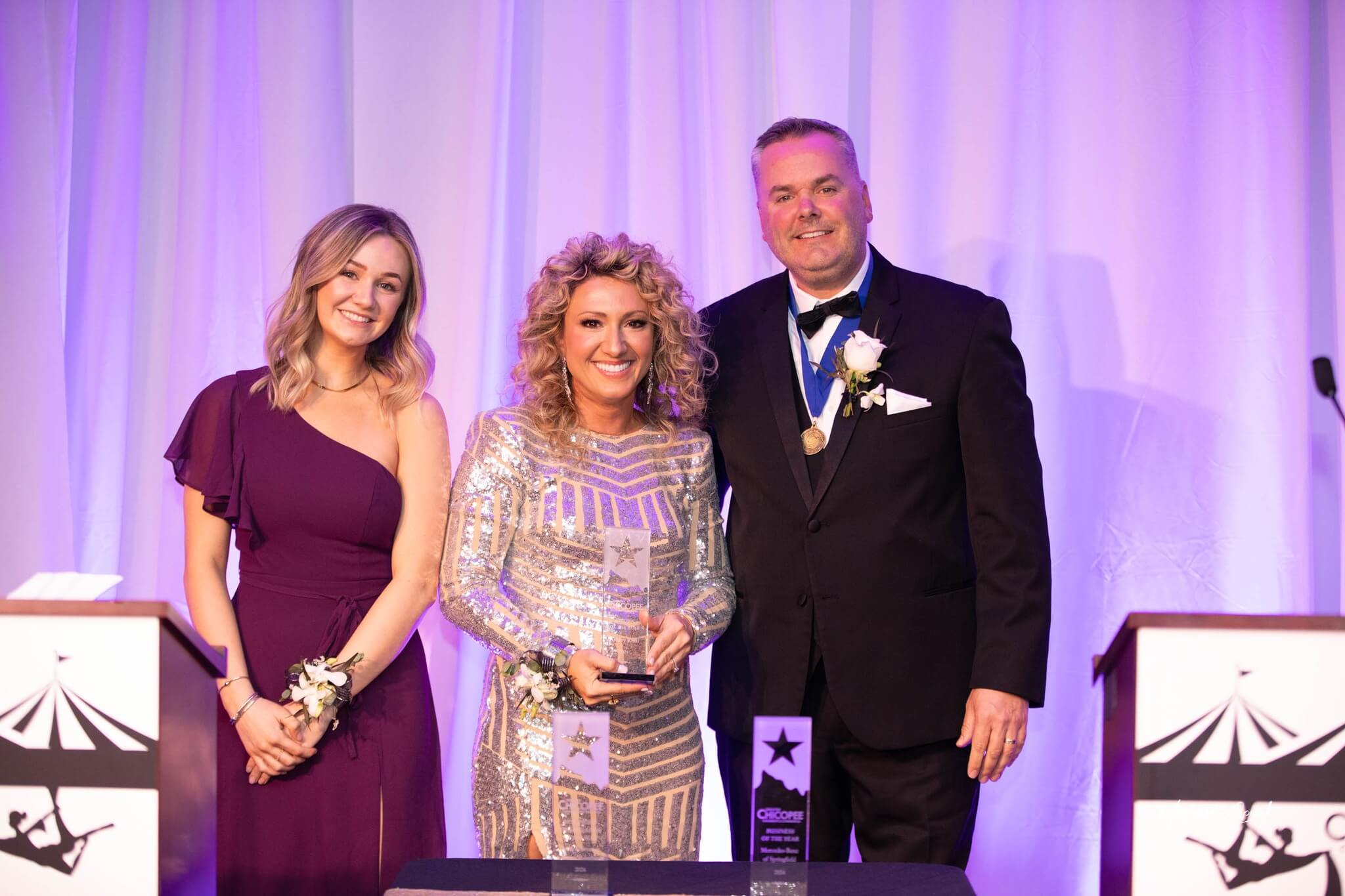 Ashley Kohl accepting the Citizen of the Year Award, with Emcees Jeremy Procon and Haley Procon.