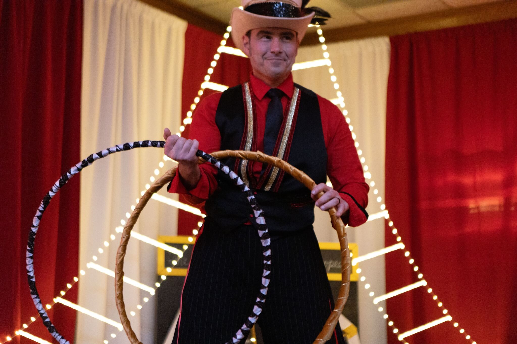 Stilt walker performing with hoops.