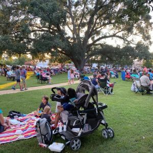 Under the Oaks event with crowds in a park