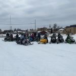 snowmobiles getting ready to go out on the trails