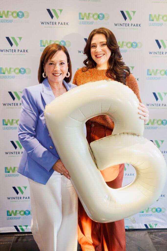 Addison Cursey and Betsy Gardner posing with a white "B" balloon