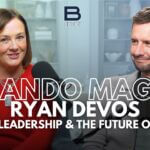 Betsy Gardner, a woman with brown hair in a red sweater, next to Ryan DeVos, a brown-haired man with a beard in a gray sweater