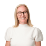 A blonde woman wearing glasses and a white shirt