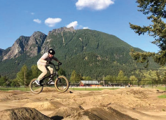 biker on bike trail with mountains in background