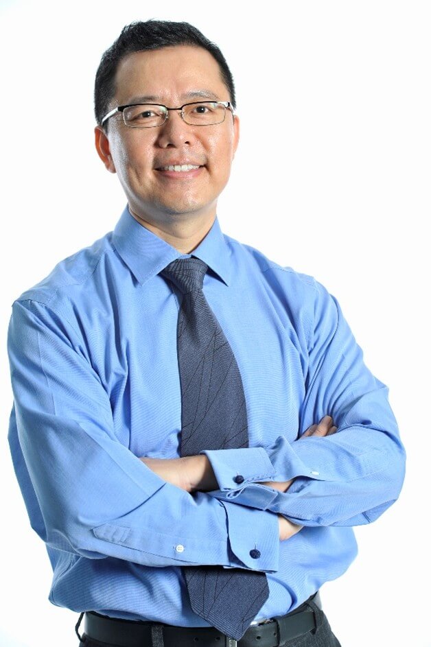 Guo_Chao headshot Picture of Dr. Chao Guo standing in a blue shirt and blue tie with his arms crossed