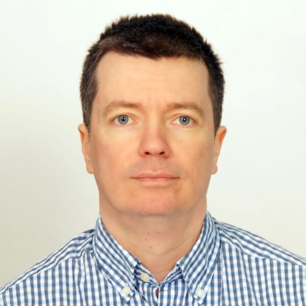 Sutiagin_Photo Anton Sutiagin's headshot. He is wearing a blue and white striped button down.