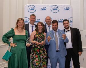This image is the NRVHBA posing for a photo, holding their awards.