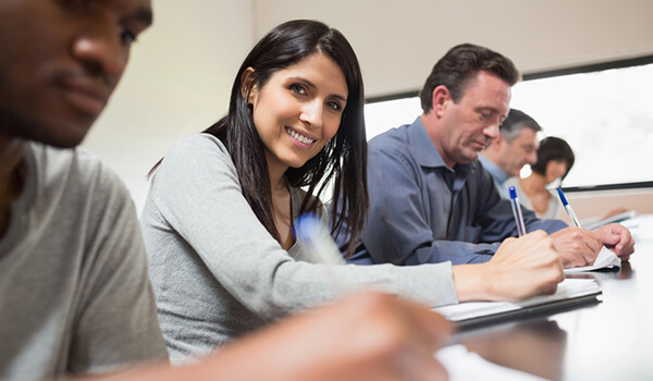 Woman looking up from lecture and smiling
