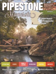 Two young people crossing bridge in front of water falls surrounded by rocks and trees at Pipestone National Monument (photo courtesy of Explore MN Tourism)