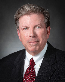 Edward Ragland man in dark suit with narrow smile