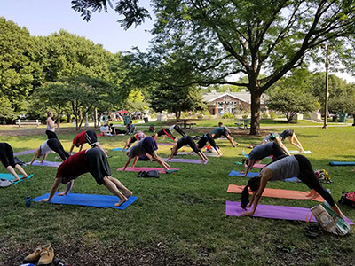 People practicing yoga in a group outdoors
