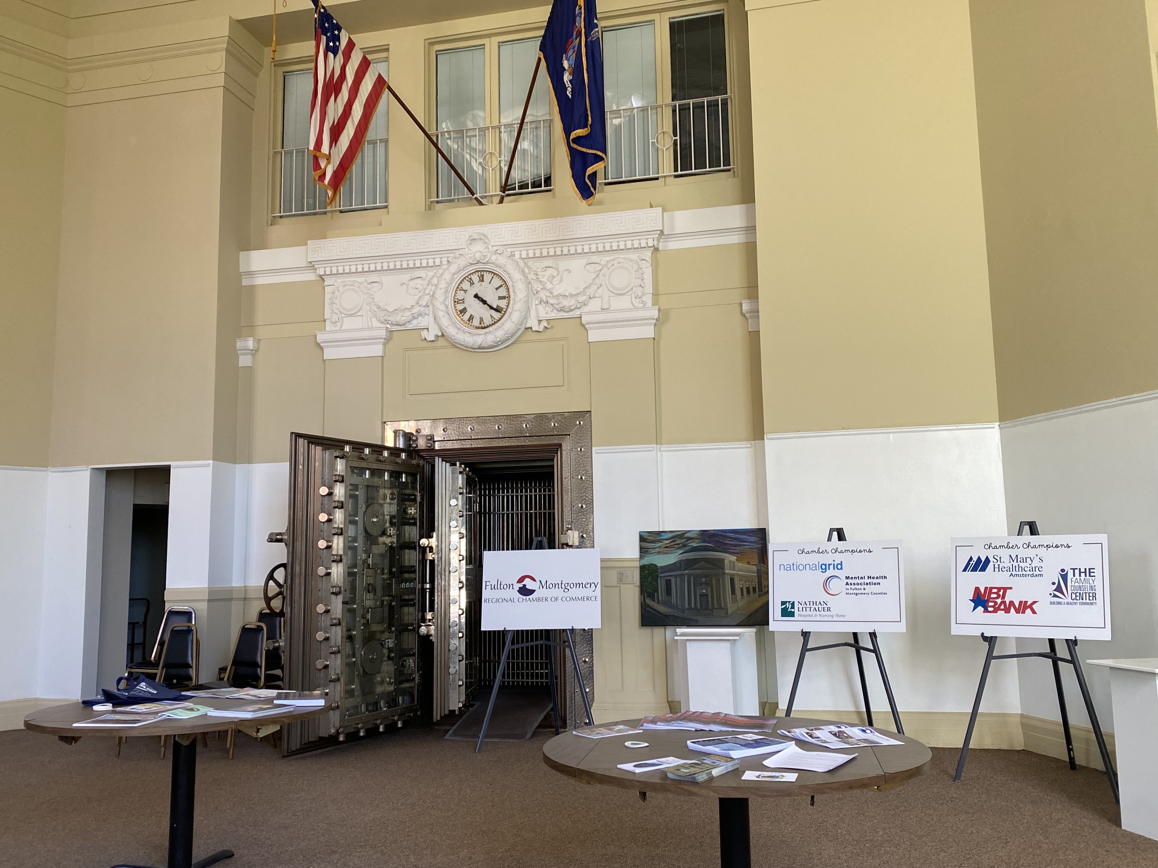 chamberGalleryTablesOct2025 Image of the bank vault, table brochures, and chamber champion signs in the main lobby
