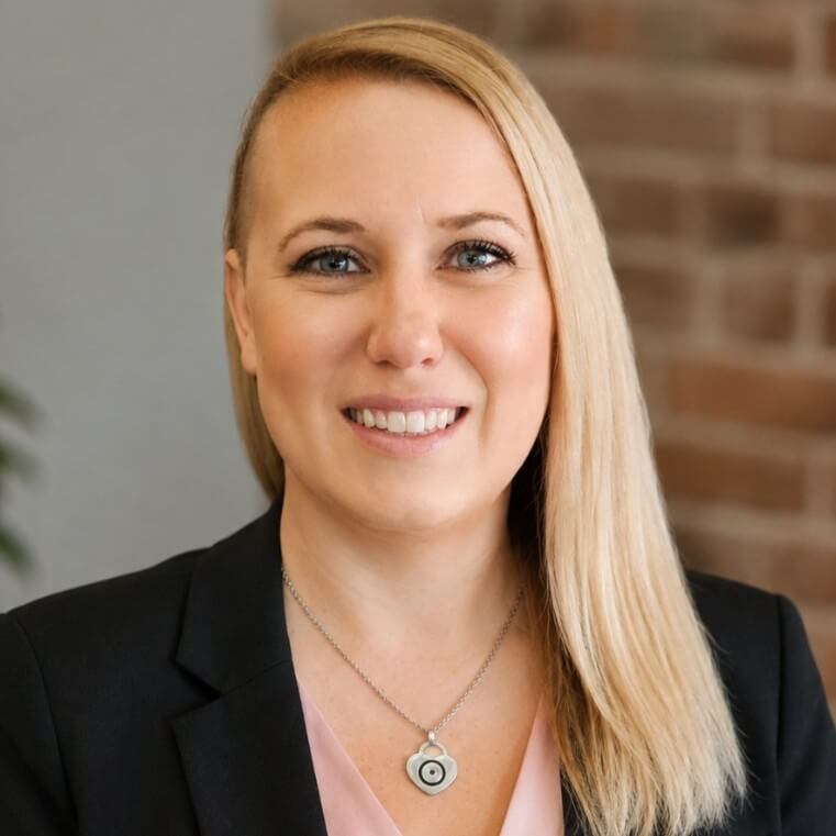 Callie Cortner in a pink shirt with black blazer smiling