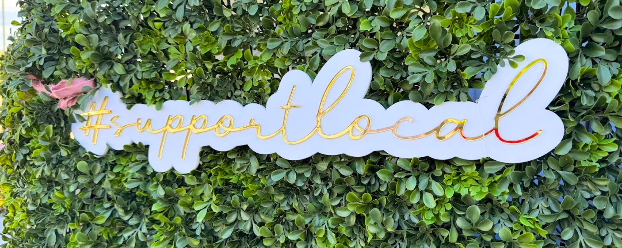 Support Local sign surrounded by greenery